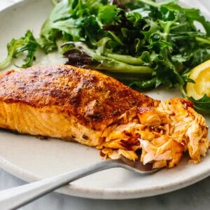 A plate of air fryer salmon and salad