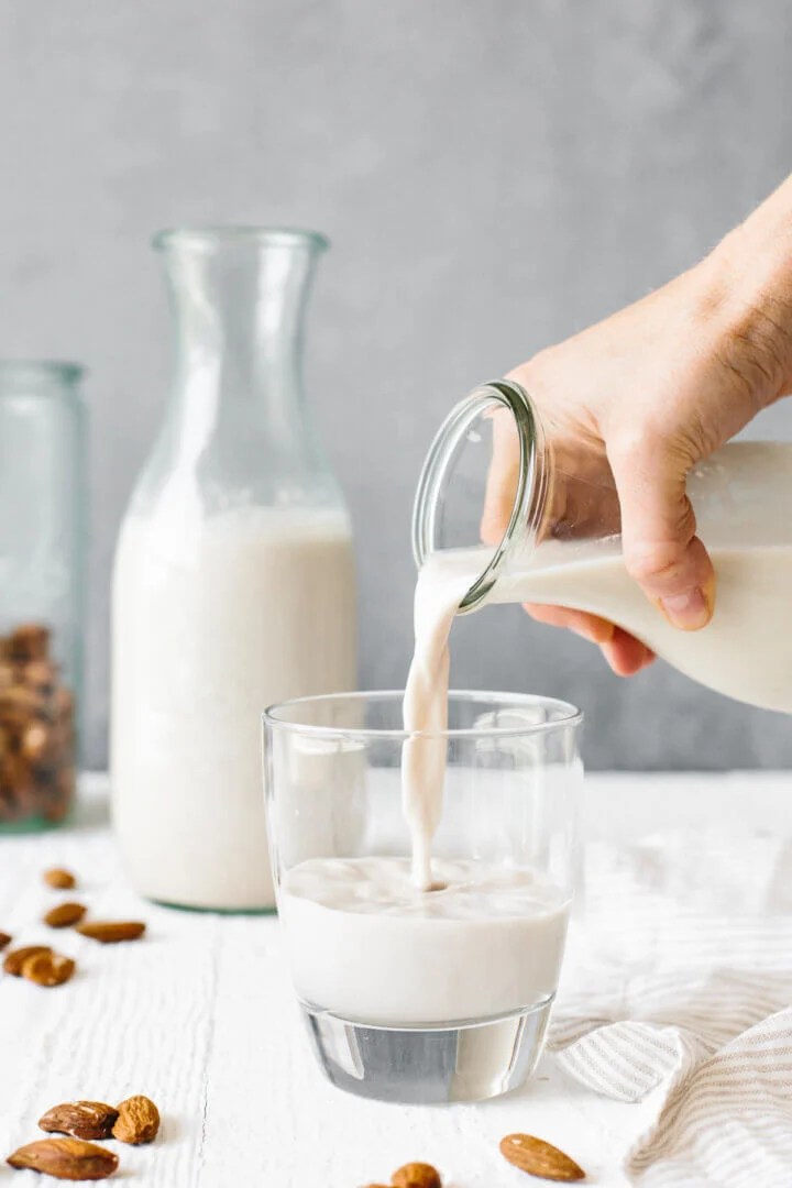 Pouring almond milk into a glass