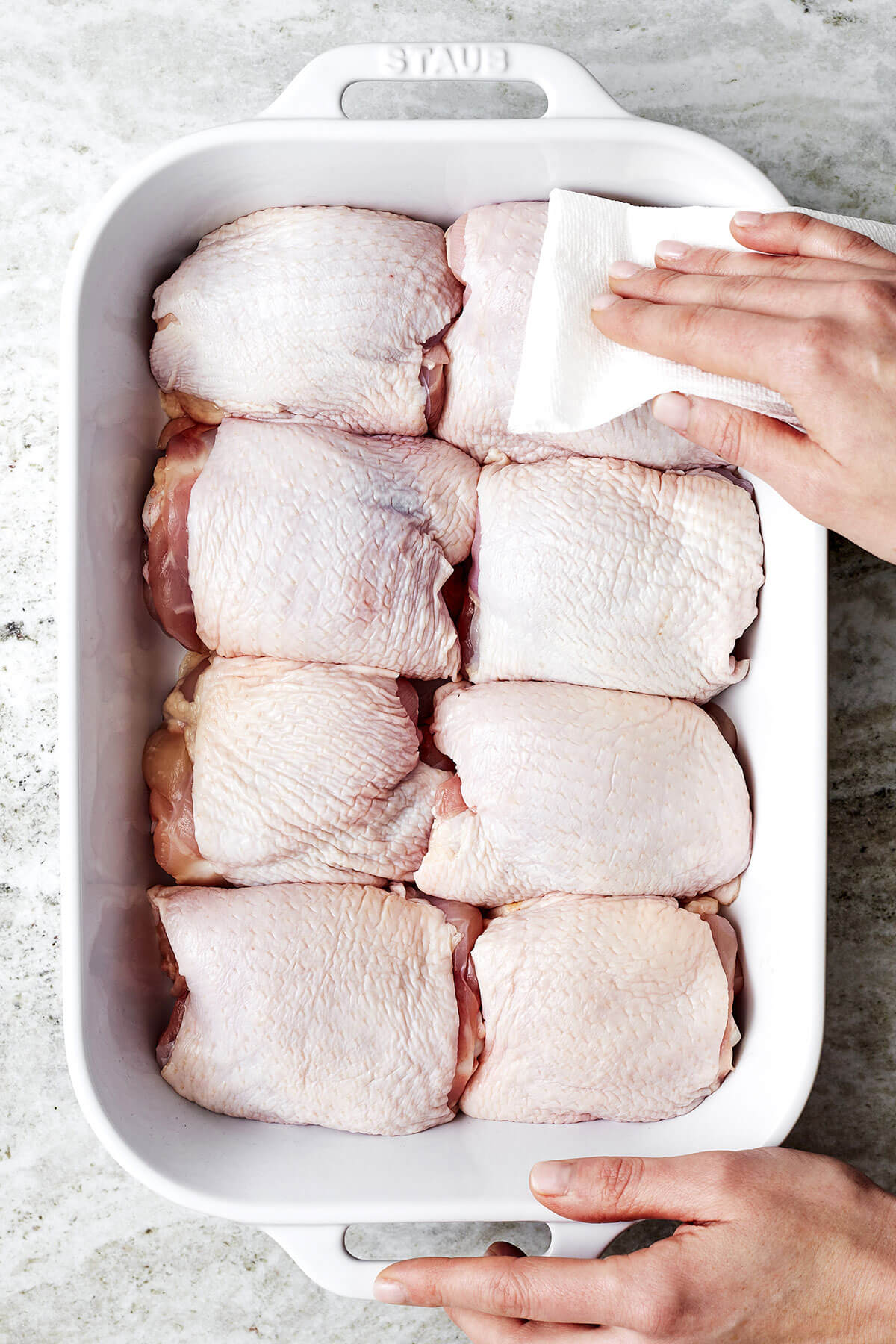 Patting chicken thighs dry before baking