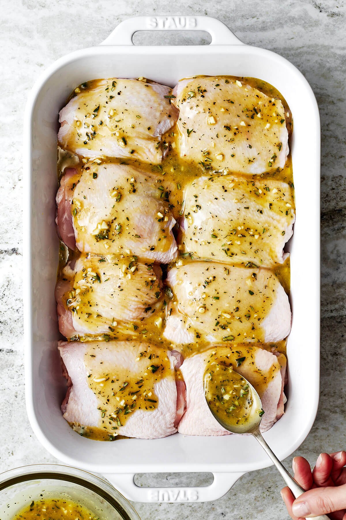 Honey mustard chicken thighs in a dish before baking