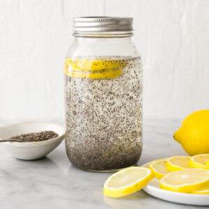 Chia seed water in a jar next to lemon slices