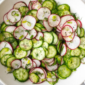A large white bowl filled with cucumber radish salad