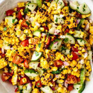Grilled corn salad in a large white bowl