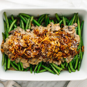 Healthy green bean casserole in a white dish on a table.