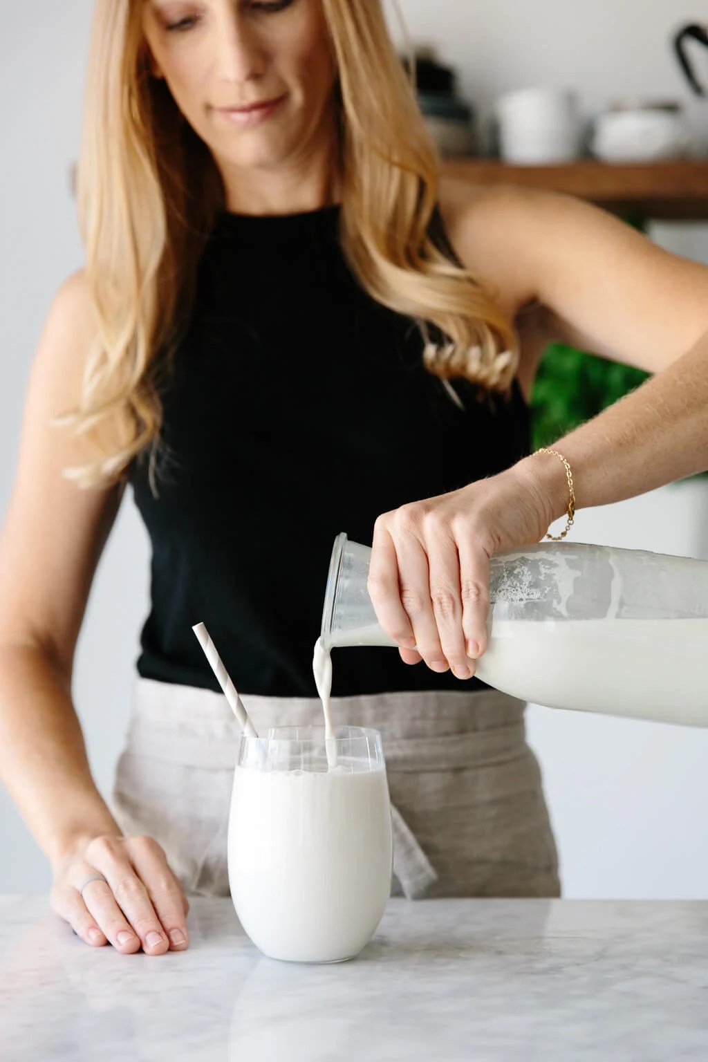 Cashew milk being poured into a glass