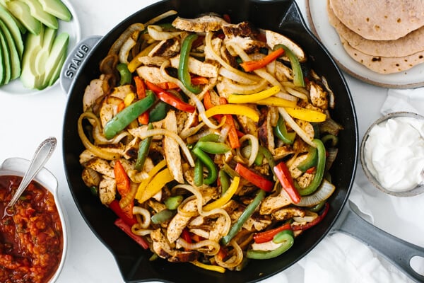 Serving the chicken fajitas with tortillas, guacamole and other ingredients.
