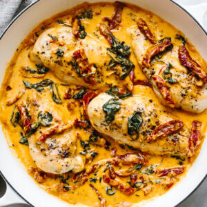 A white skillet of tuscan chicken