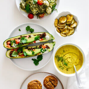 Zucchini recipes laid out on a table.